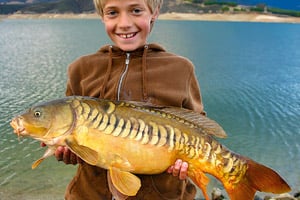young angler with carp